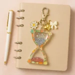 ChatGPT Image May 23 2025 08_51_08 PM โข Bling On- Resin-Handmade-Vintage-Sand-Time-Glitter-Epoxy-Fruit-Hourglass-Keychain-diary-journal-for-time-manment