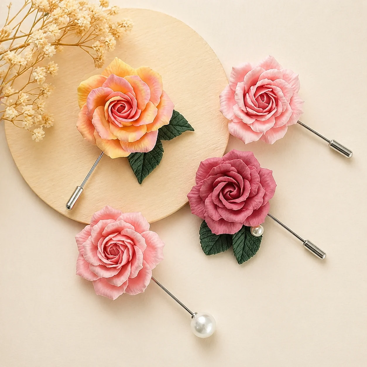 Decorative hair pins with pink and peach rose blooms, green leaves, and pearl tips on a light wooden circle backdrop.