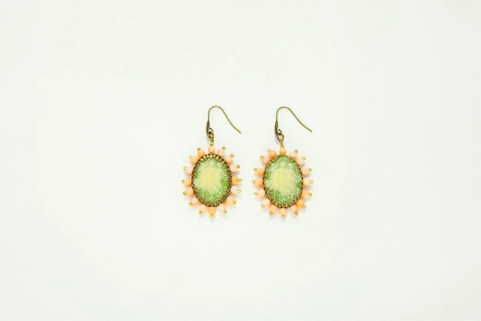 a pair of green and yellow earrings